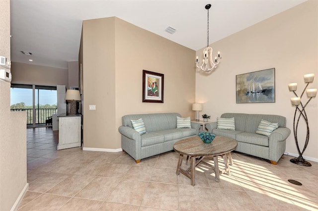 living room with light tile patterned flooring and a notable chandelier