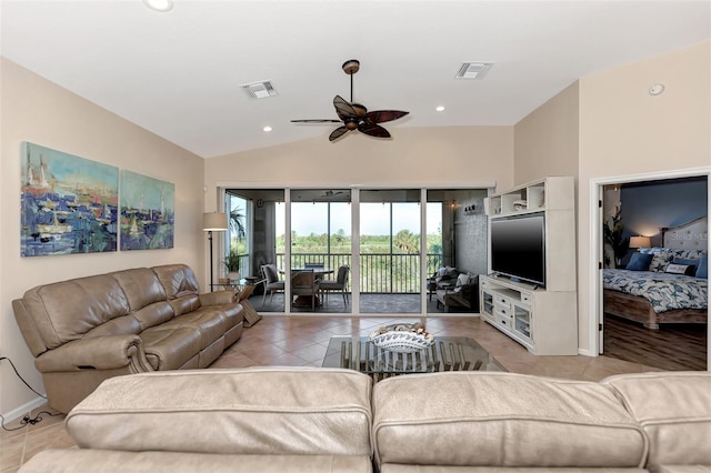 living room with lofted ceiling, ceiling fan, and light tile patterned flooring