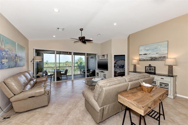 tiled living room with ceiling fan and vaulted ceiling