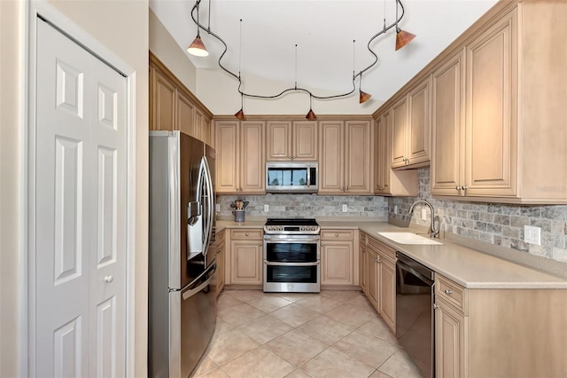 kitchen featuring stainless steel appliances, sink, light tile patterned floors, backsplash, and light brown cabinets