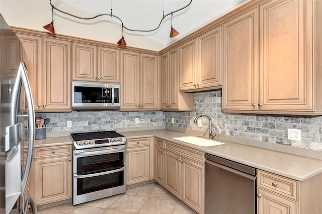 kitchen with stainless steel appliances, sink, tasteful backsplash, light brown cabinets, and light tile patterned floors