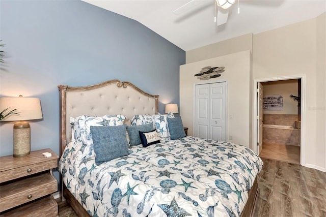 bedroom with a closet, ensuite bath, hardwood / wood-style floors, lofted ceiling, and ceiling fan