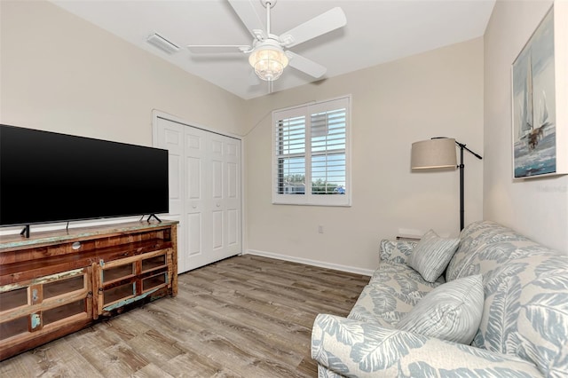 living room with hardwood / wood-style floors and ceiling fan