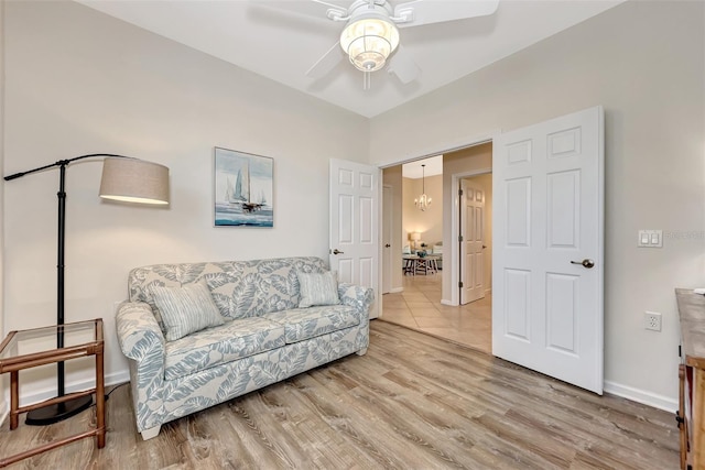 living area with ceiling fan and light wood-type flooring