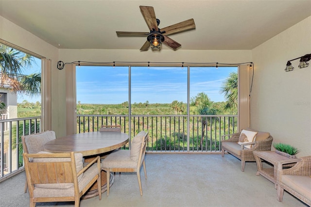 sunroom / solarium featuring a wealth of natural light and ceiling fan