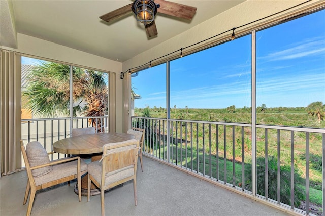 sunroom featuring ceiling fan