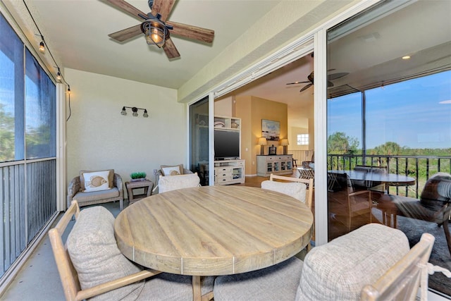 sunroom featuring ceiling fan