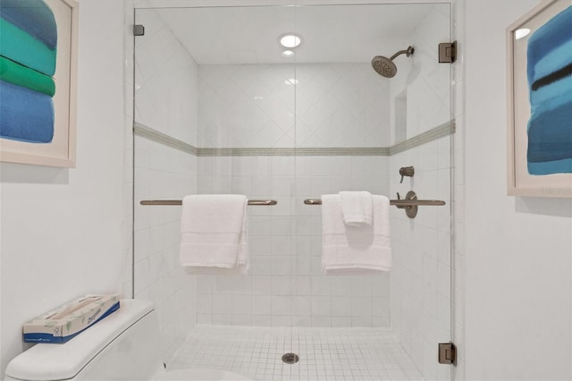 bathroom with an enclosed shower and toilet