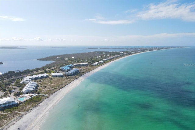 drone / aerial view with a beach view and a water view