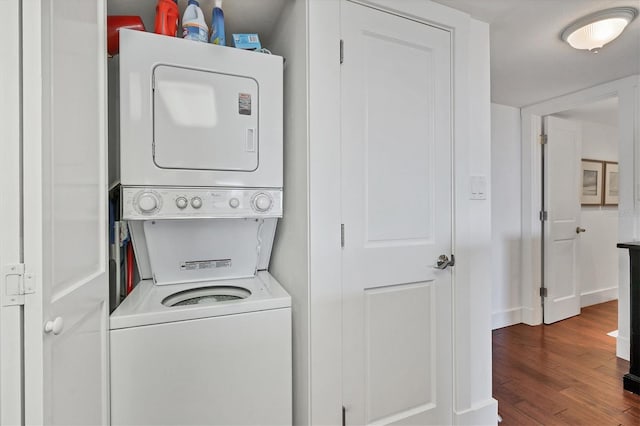 laundry area featuring hardwood / wood-style floors and stacked washing maching and dryer