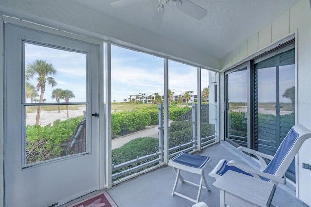 unfurnished sunroom featuring plenty of natural light and ceiling fan