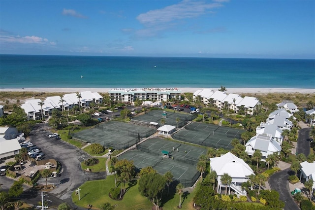 birds eye view of property with a beach view and a water view