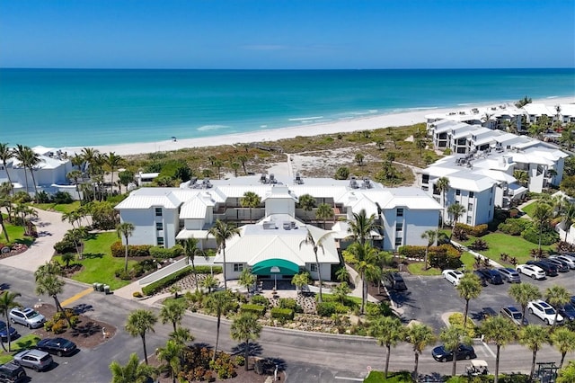 drone / aerial view with a beach view and a water view