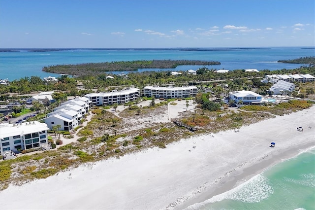 bird's eye view with a water view and a beach view