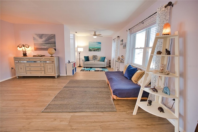 sitting room featuring light hardwood / wood-style flooring and ceiling fan