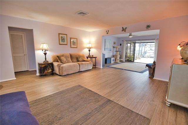 living room featuring ceiling fan and light wood-type flooring