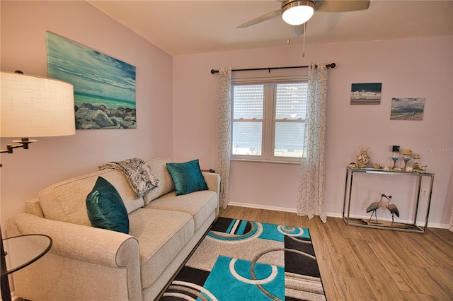 living room featuring hardwood / wood-style floors and ceiling fan