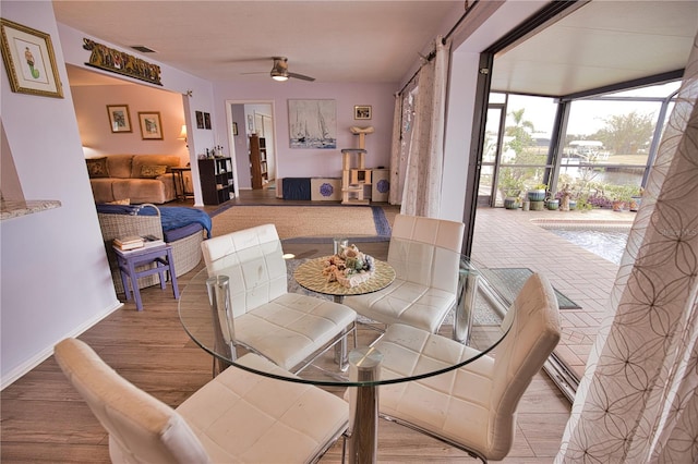 dining space featuring hardwood / wood-style flooring and ceiling fan