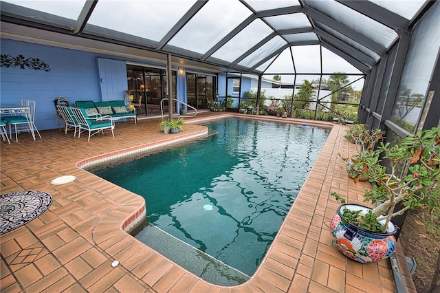 view of swimming pool with a patio and glass enclosure