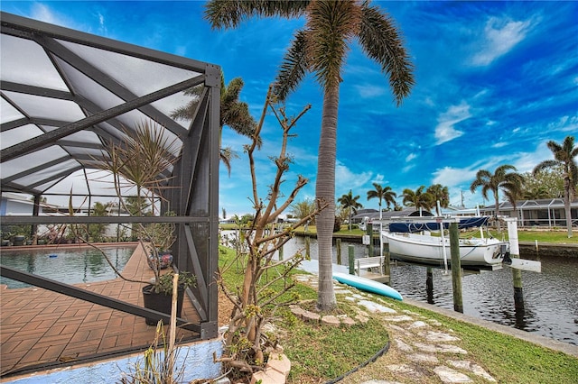 view of dock featuring glass enclosure and a water view