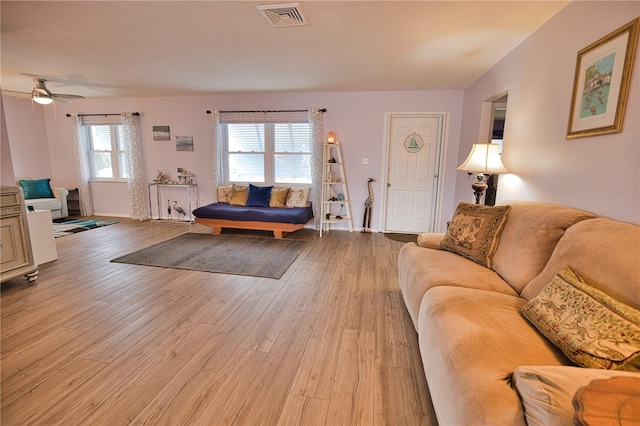 living room with ceiling fan and light wood-type flooring