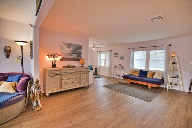 living room with ceiling fan and light wood-type flooring