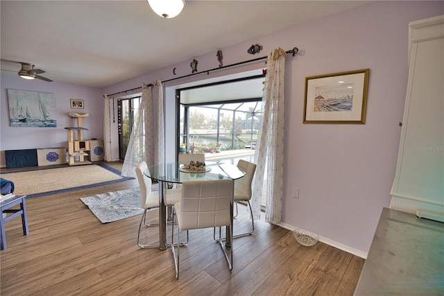 dining room featuring ceiling fan and hardwood / wood-style flooring