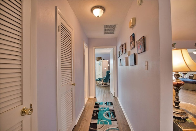 hallway with wood-type flooring