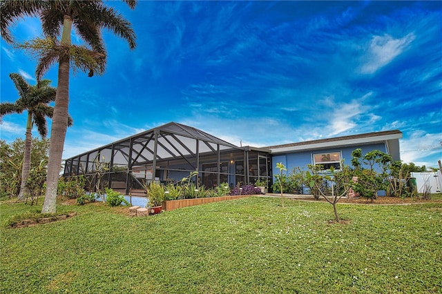 back of property featuring a yard and a lanai