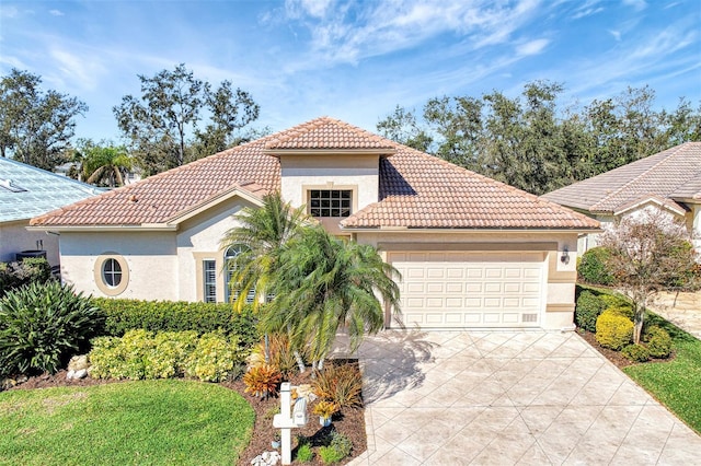 mediterranean / spanish house featuring a garage