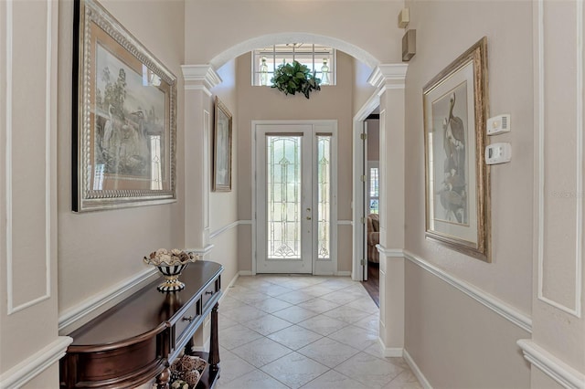 tiled foyer featuring ornate columns