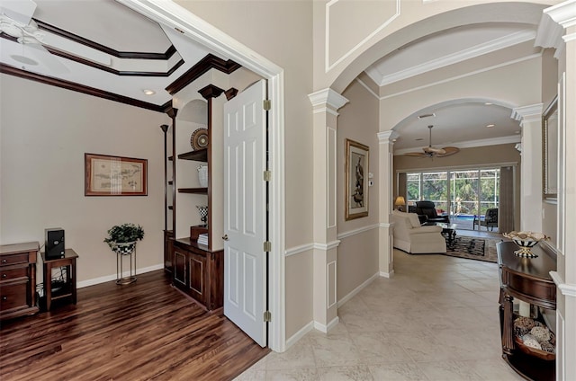 hall with ornamental molding, light hardwood / wood-style floors, and ornate columns