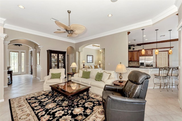 living room featuring ornate columns, ceiling fan, crown molding, and light tile patterned floors