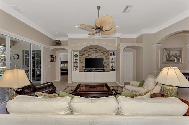 living room with ceiling fan, ornamental molding, and decorative columns