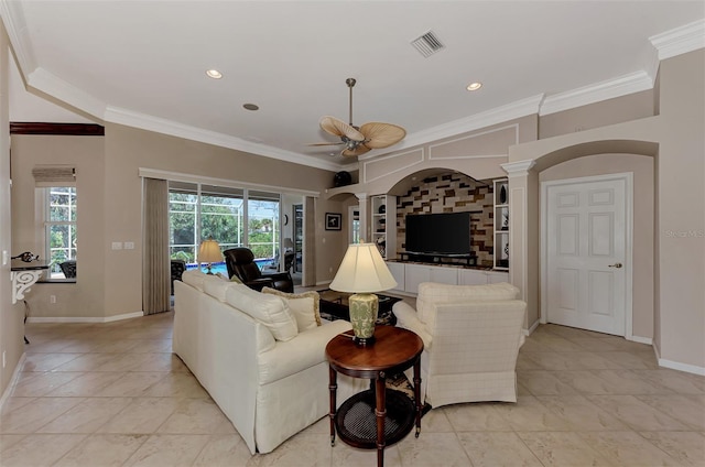 living room featuring ornamental molding, decorative columns, and ceiling fan