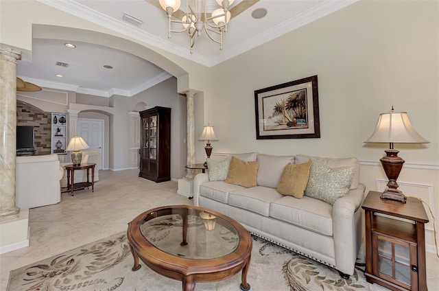 living room featuring a notable chandelier, crown molding, and decorative columns