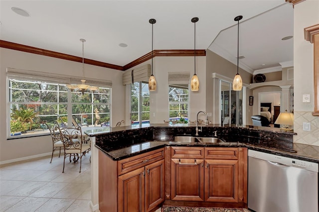 kitchen featuring dishwasher, hanging light fixtures, dark stone countertops, and plenty of natural light