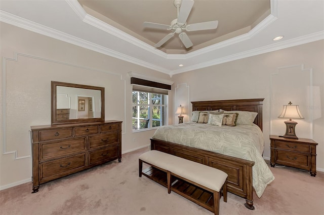 carpeted bedroom featuring ornamental molding, ceiling fan, and a tray ceiling