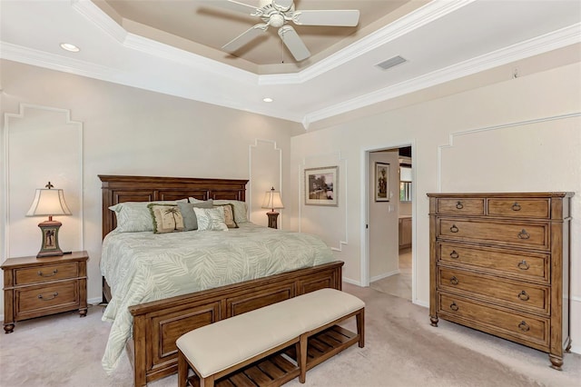 bedroom with a tray ceiling, light carpet, ceiling fan, and crown molding