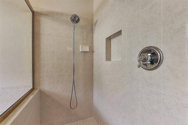 bathroom with a tile shower