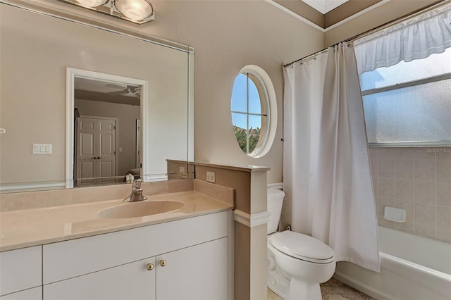 full bathroom featuring toilet, vanity, shower / bath combo with shower curtain, and a healthy amount of sunlight