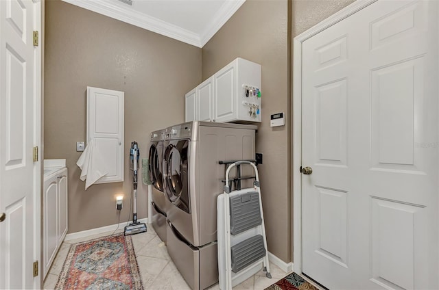 laundry room with cabinets, light tile patterned flooring, separate washer and dryer, and ornamental molding