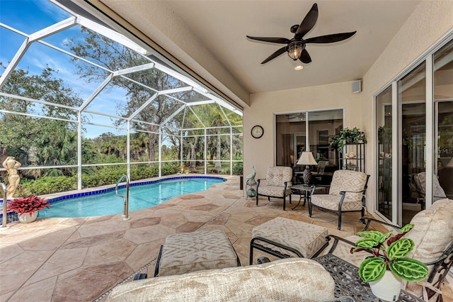 view of pool with a lanai, ceiling fan, and a patio