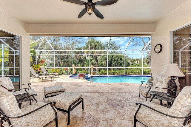 view of swimming pool with a patio area, a lanai, and ceiling fan