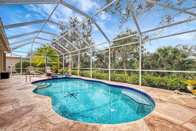 view of pool featuring a lanai, an in ground hot tub, and a patio area