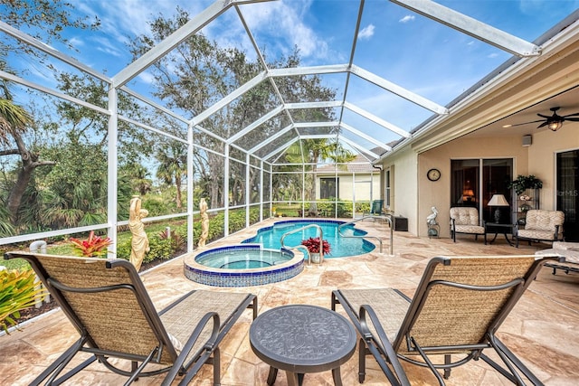 view of swimming pool with glass enclosure, a patio, ceiling fan, and an in ground hot tub