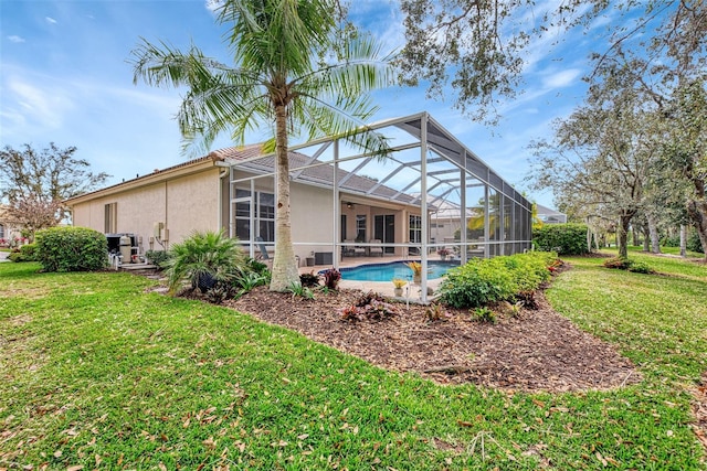 rear view of house featuring a lanai and a yard