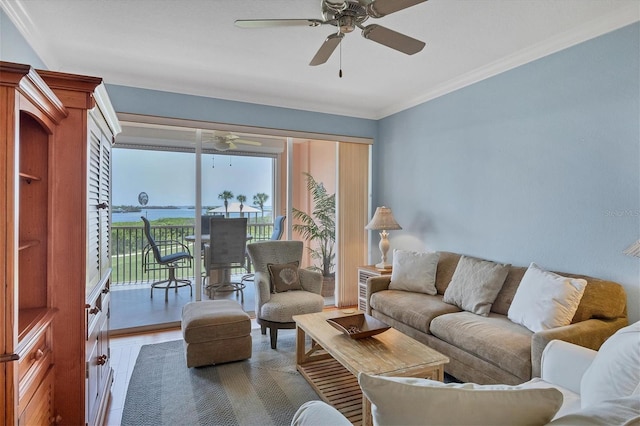 living room with ceiling fan, wood-type flooring, and ornamental molding