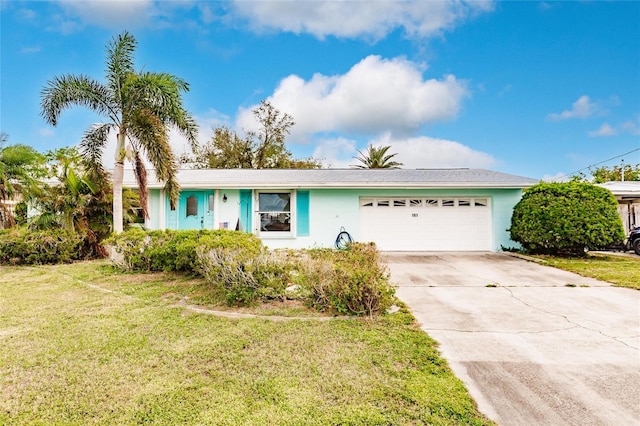 ranch-style home with a front lawn and a garage