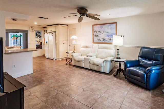 tiled living room with ceiling fan